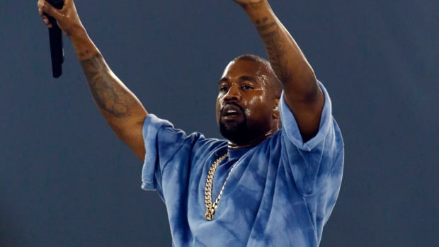 Kanye West performs during a concert.
